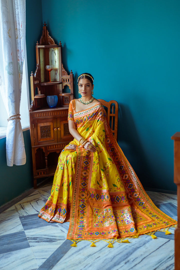 Exquisite Yellow Banarasi saree with Patola weaving, perfect for an Indian wedding or formal gathering.