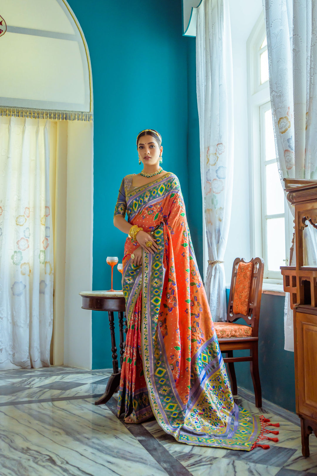 Orange fancy saree with rich zari border and pallu, ideal for traditional events and Indian weddings.