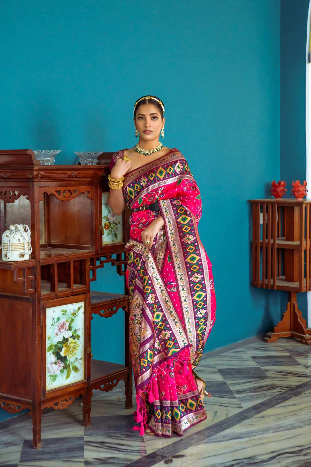 Bright pink Indian sari with intricate weaving and rich border, a perfect addition to any festive wardrobe.