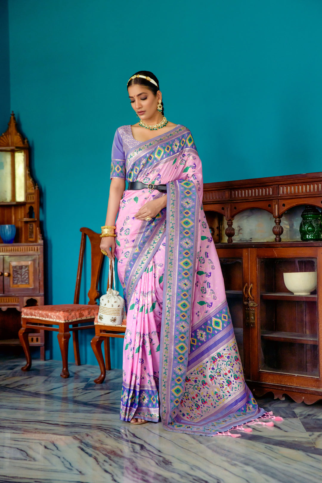 Stylish Pink Indian saree with Patola weaving, ideal for festive gatherings and cultural events.