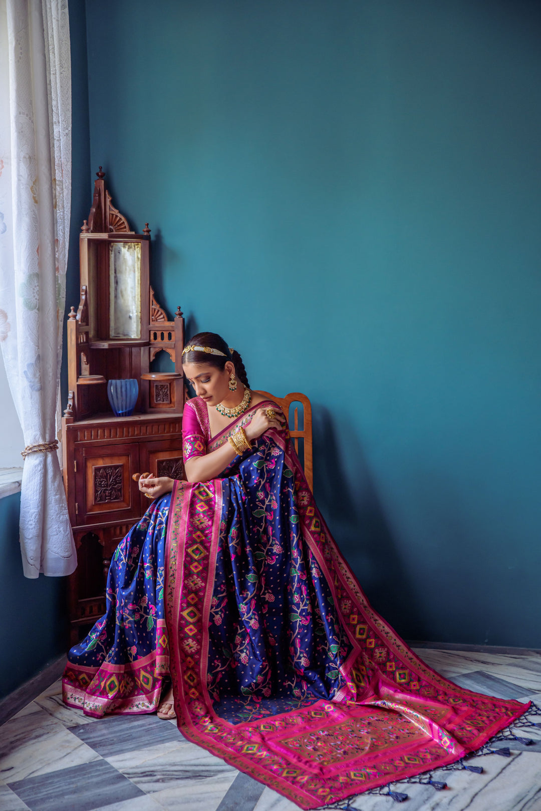 Radiant Navy blue Indian saree with luxurious Patola weaving and lace border, perfect for special events.