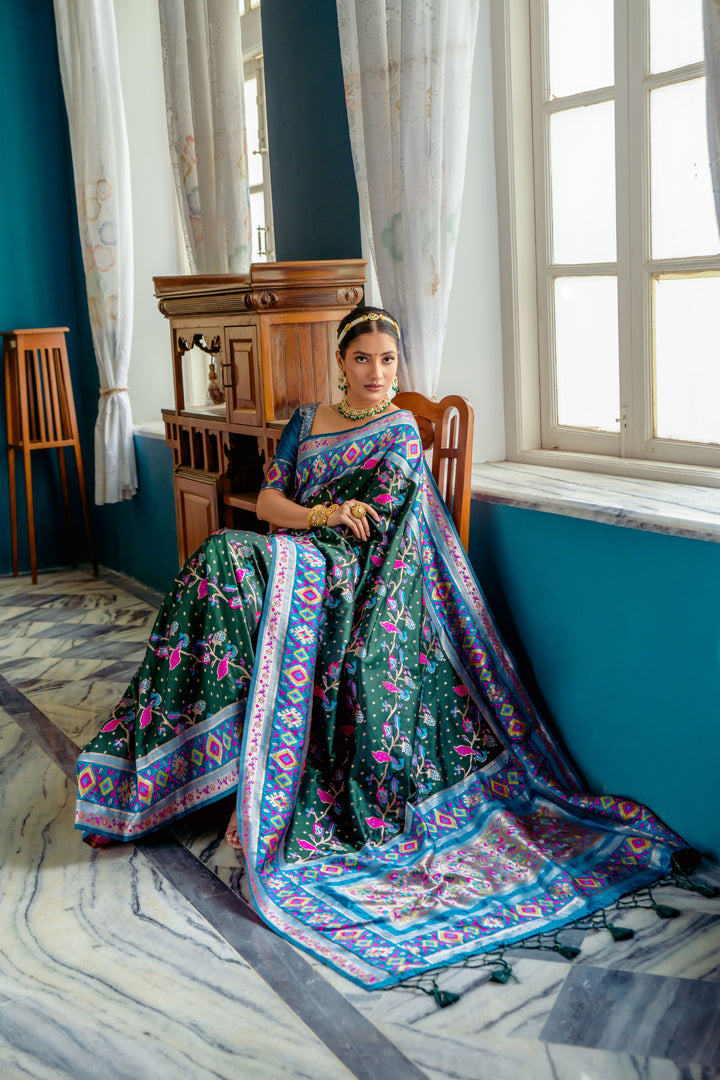 Beautiful Green Indian saree with exquisite Patola weaving and intricate meena details, ideal for weddings.