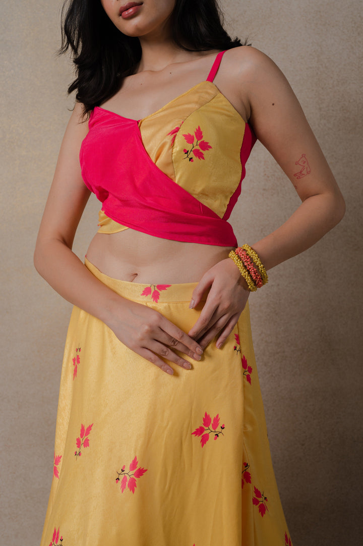 Stylish pink and yellow phulkari lehenga set with a contemporary wrap blouse and flowing organza dupatta, ideal for celebrations.