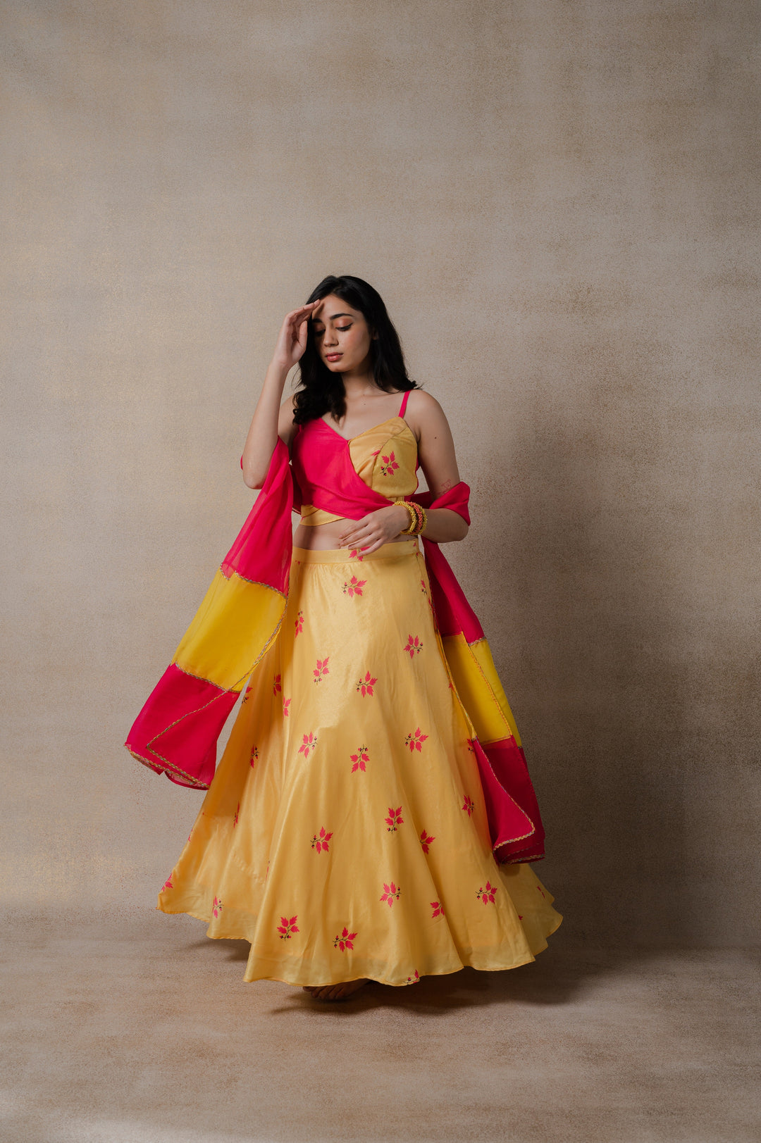 Chic pink and yellow phulkari lehenga set featuring a modern wrap blouse and organza dupatta, perfect for festive occasions.