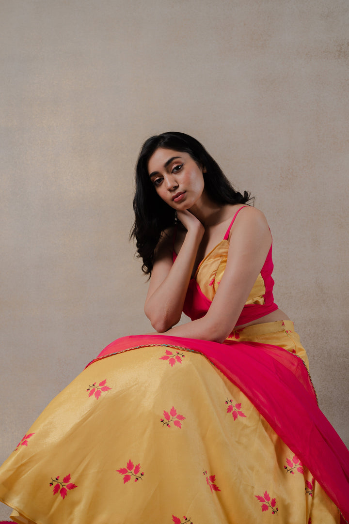 Modern pink and yellow lehenga set with intricate phulkari work, complemented by a wrap blouse and elegant organza dupatta.