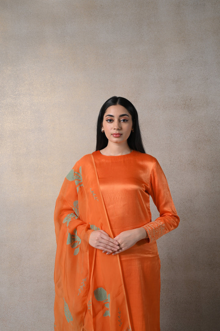 Vibrant orange Kamakhya suit set with elegant detailing, making it an ideal choice for ethnic wear lovers.