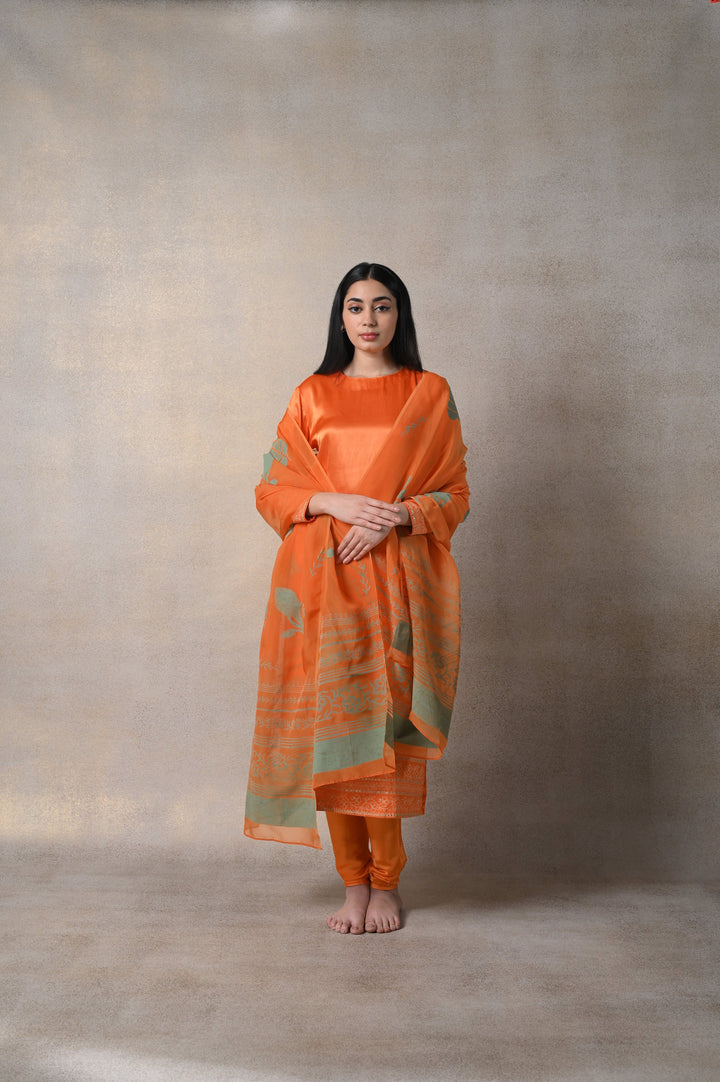 Gorgeous orange Kamakhya suit set, showcasing traditional craftsmanship ideal for parties and celebrations.