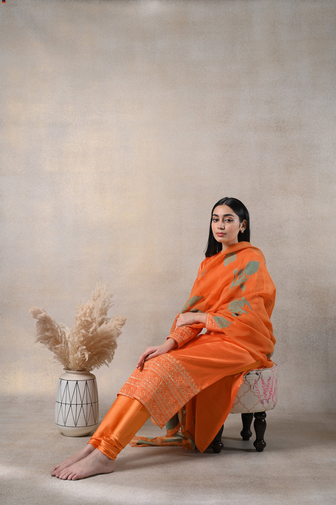 Beautiful orange Kamakhya suit set featuring intricate ethnic designs, perfect for festive occasions.