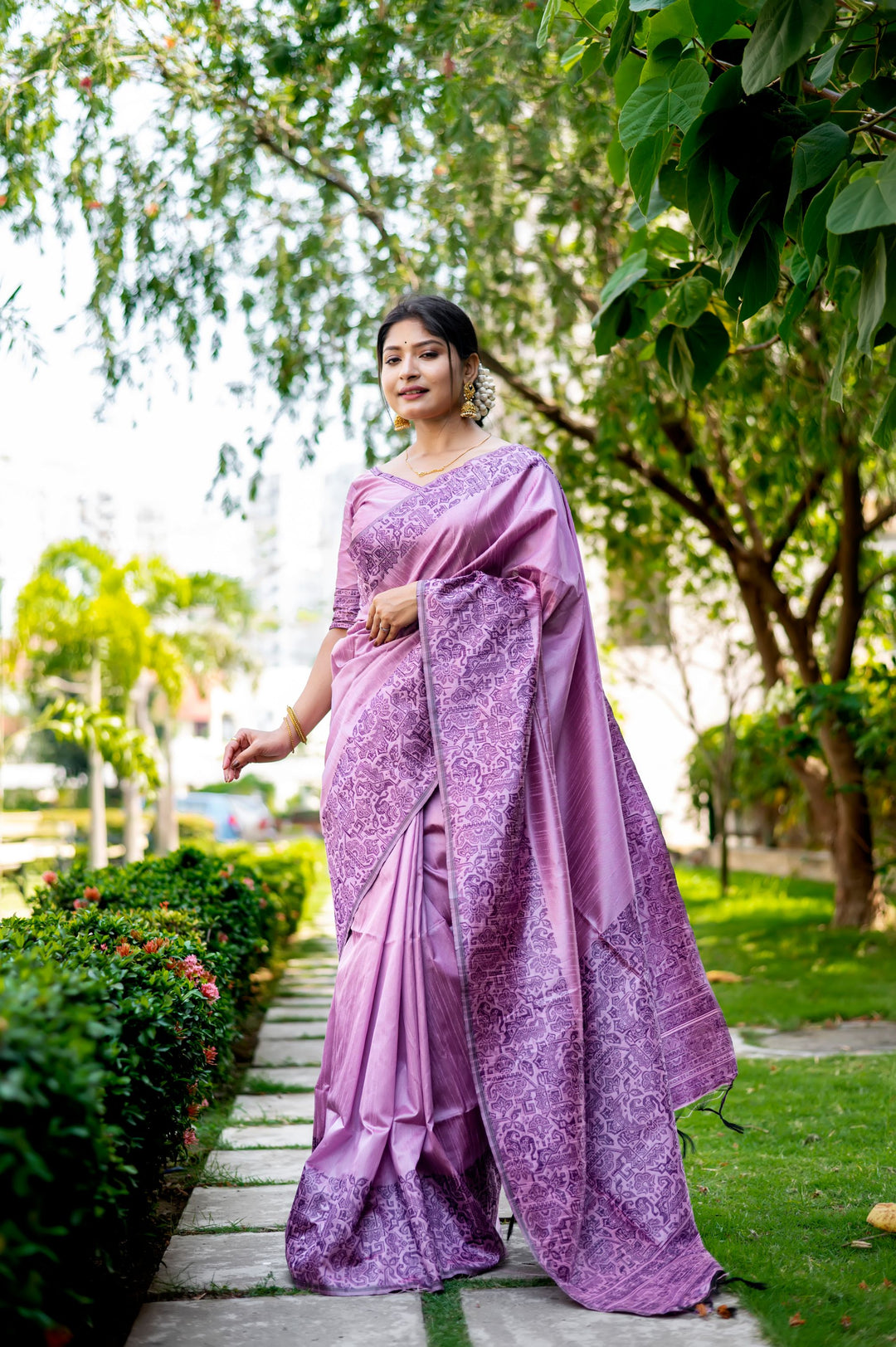 Gorgeous lavender-dream handloom raw silk saree with intricate weaving pallu and matching blouse piece, ideal for festive celebrations.