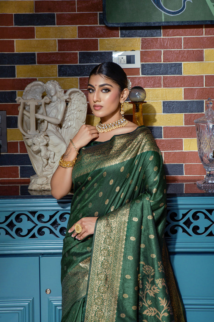 Step into luxury with this Dark green Designer saree featuring intricate zari weaving and a running blouse piece for a complete look.