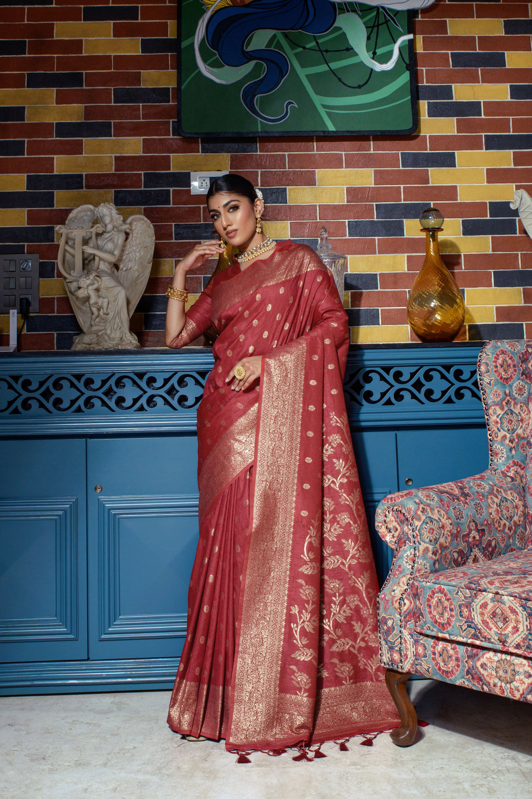 Gorgeous crimson red fancy sarees featuring a rich zari border and luxurious tassels, ideal for cultural celebrations and weddings.