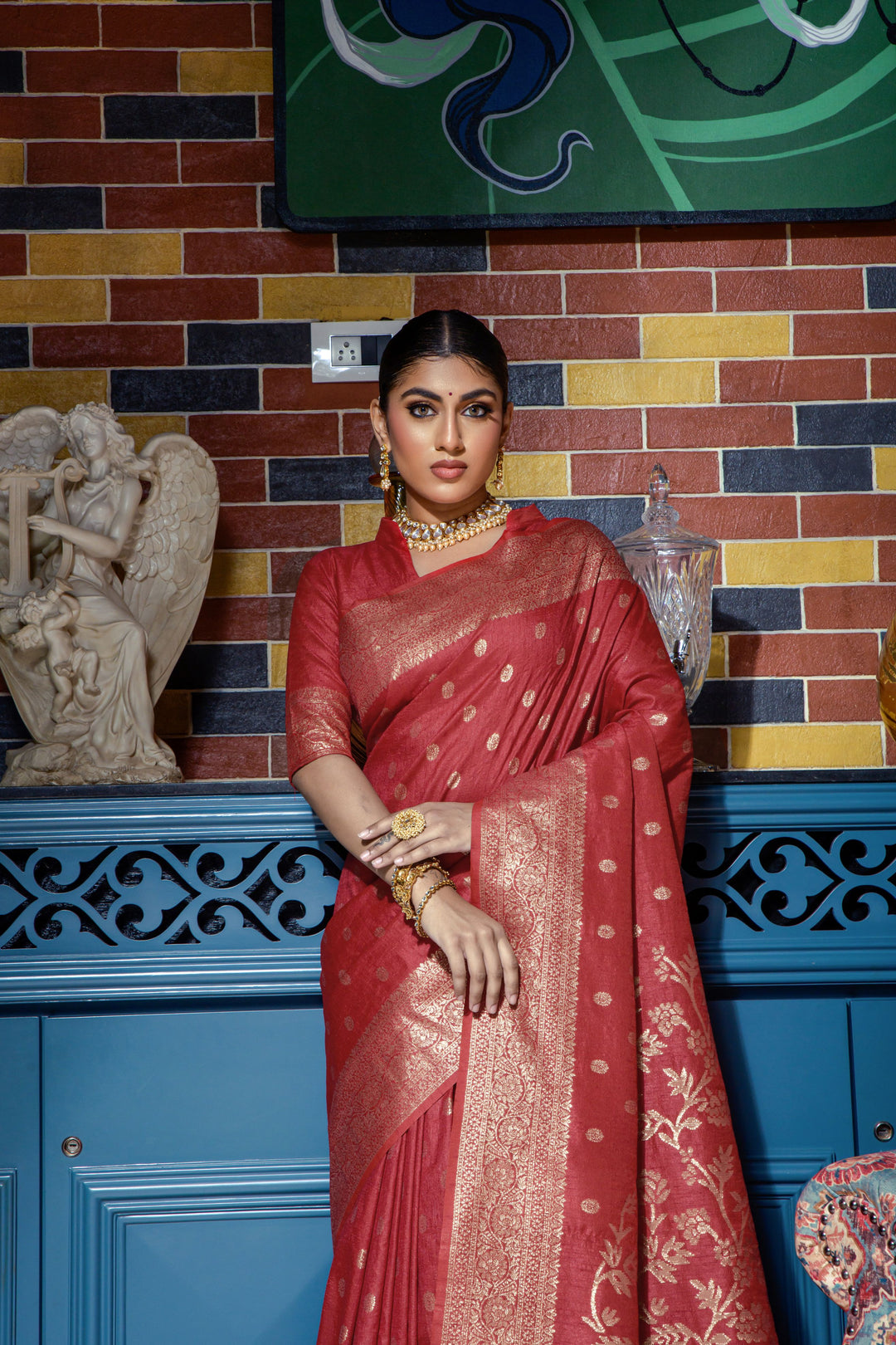 Stunning crimson red saree with intricate zari work, perfect for weddings and festive occasions, complete with a running blouse piece.