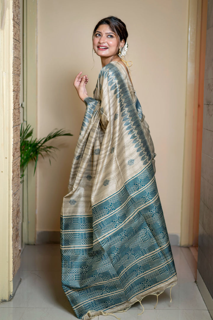 Beautiful green Tussar silk saree with intricate weaving and a striking pallu design, perfect for cultural celebrations.