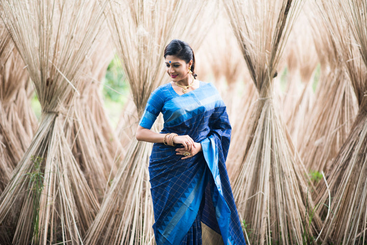 Elegant raw silk saree featuring a zari pallu, temple border, and tassels