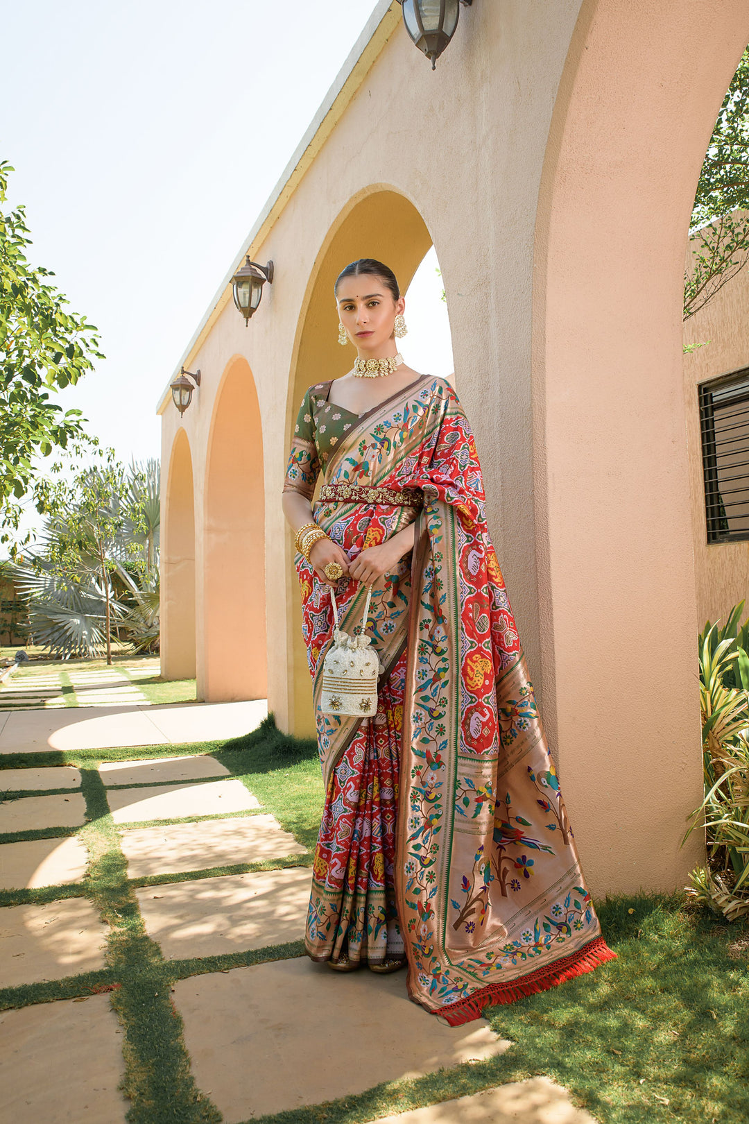 Red Banarasi saree with Paithani-style border and colorful lace, ideal for Indian weddings and cultural events.