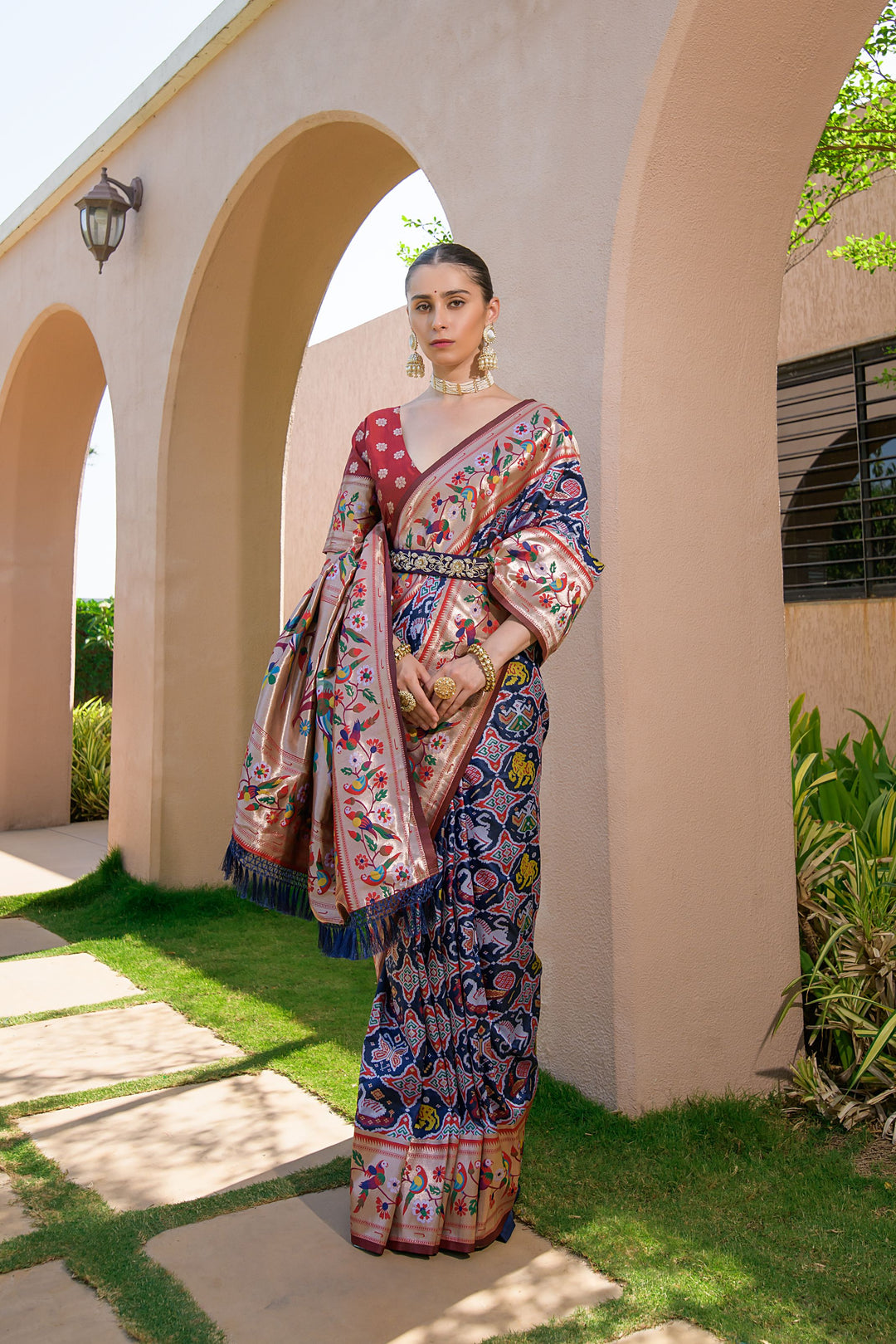 Navy blue Indian wedding saree with designer Paithani Patola weaving, ideal for special cultural attire.