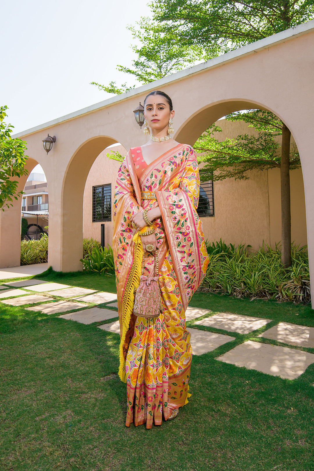 Yellow Indian saree with Paithani-style border and rich pallu, ideal for festive celebrations and weddings.