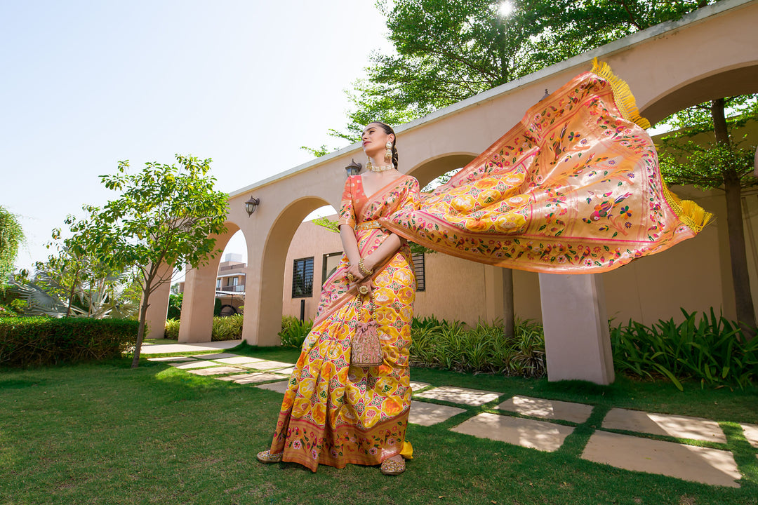 Yellow Indian saadi with intricate Paithani Patola design, offering a sophisticated and traditional look for events.