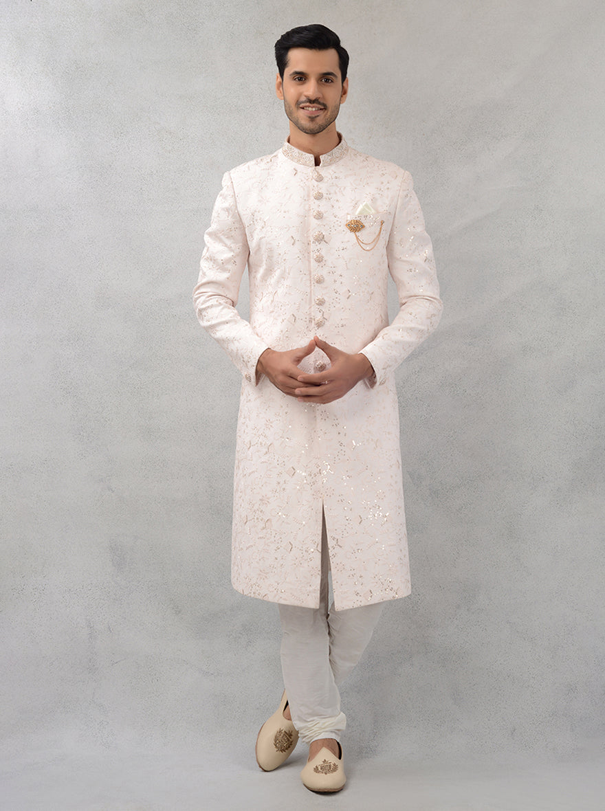 This elegant cream georgette sherwani blends charm with modern style, perfect for grooms seeking a refined appearance on their special day.