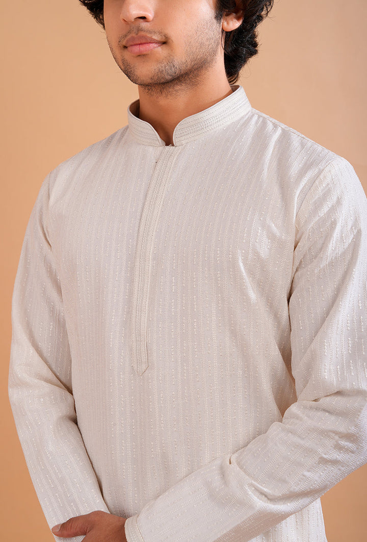 Men’s embroidered cream kurta pajama set, perfect for poojas, weddings, and festive gatherings.