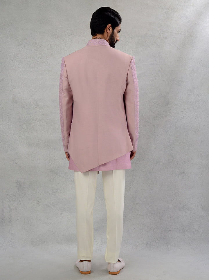 Experience luxury with our Pink Silk Jacquard attire, featuring intricate embroidery and an asymmetrical cut for style.