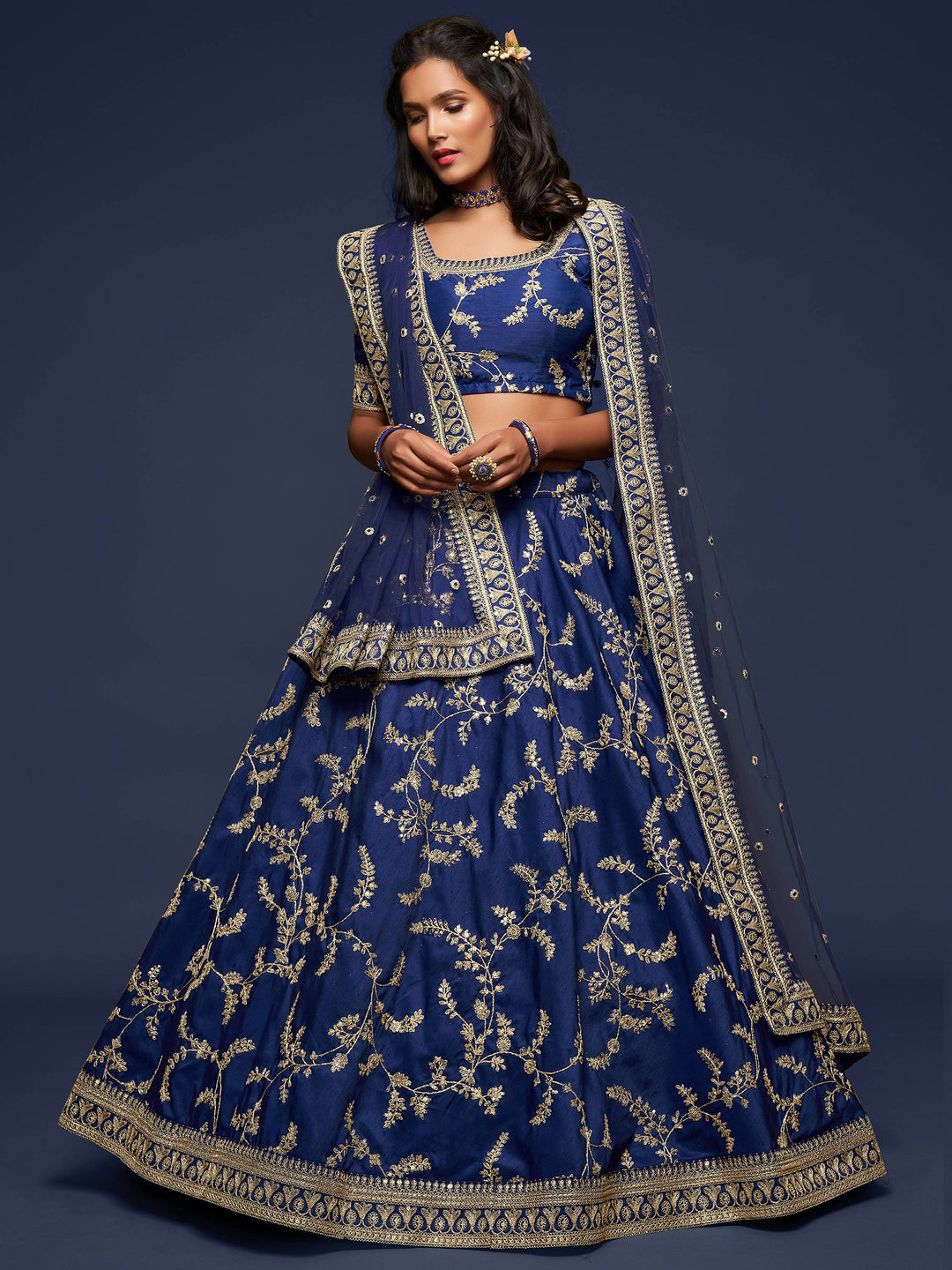 Bridal blue lehenga with matching choli and embroidered net dupatta.