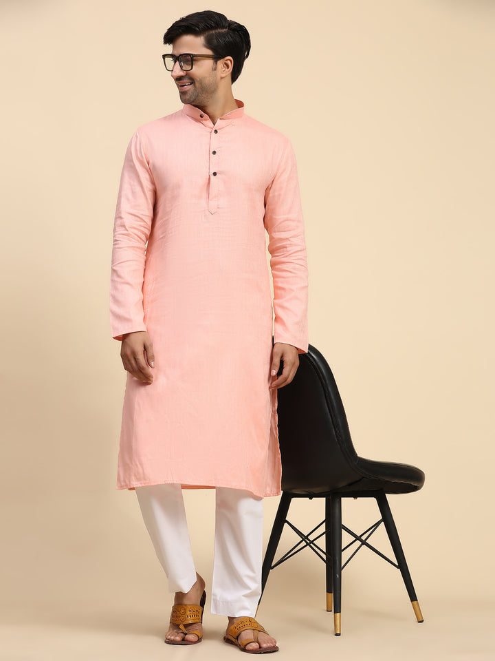 Men’s baby pink kurta pajama set with full-weaved embroidery for a traditional look.