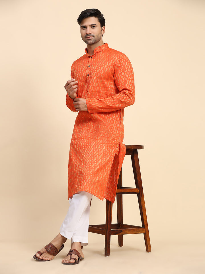 Festive orange kurta pajama with handwoven embellishments, perfect for traditional events.