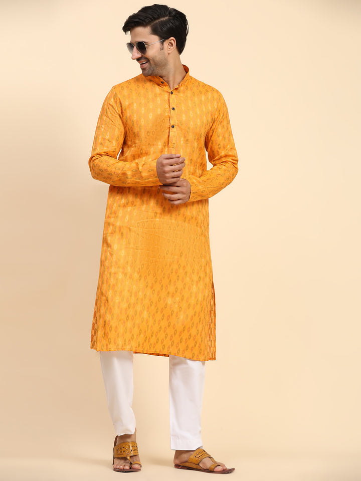 Light orange traditional men’s kurta set with handwoven embellishments.