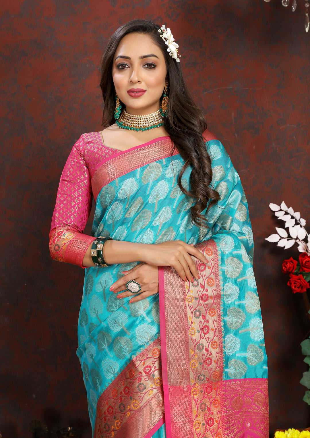 Turquoise Organza silk saree featuring luxurious Meenakari details, ideal for grand Indian events.