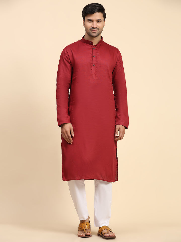 Maroon kurta pajama set for men with intricate embroidery for festive wear.