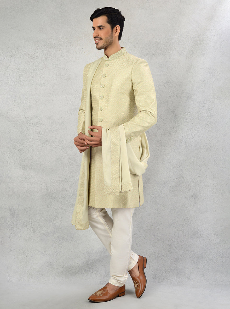 Elevate your wedding wardrobe with this pista green silk blend sherwani, showcasing a classic silhouette and luxurious embroidery for an elegant appearance.