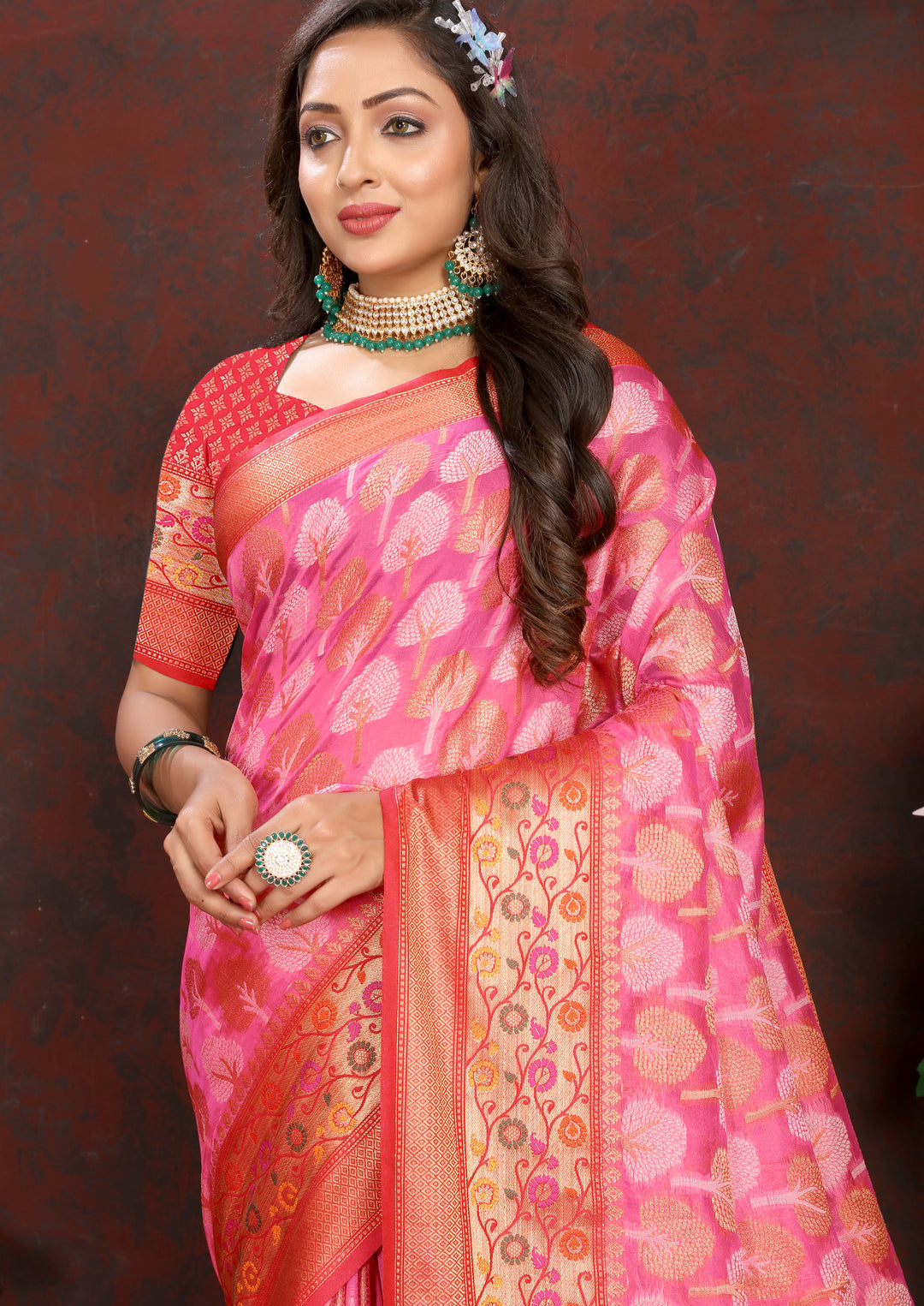 Classic coral pink Meenakari Organza silk saree with detailed artistry, perfect for grand celebrations.