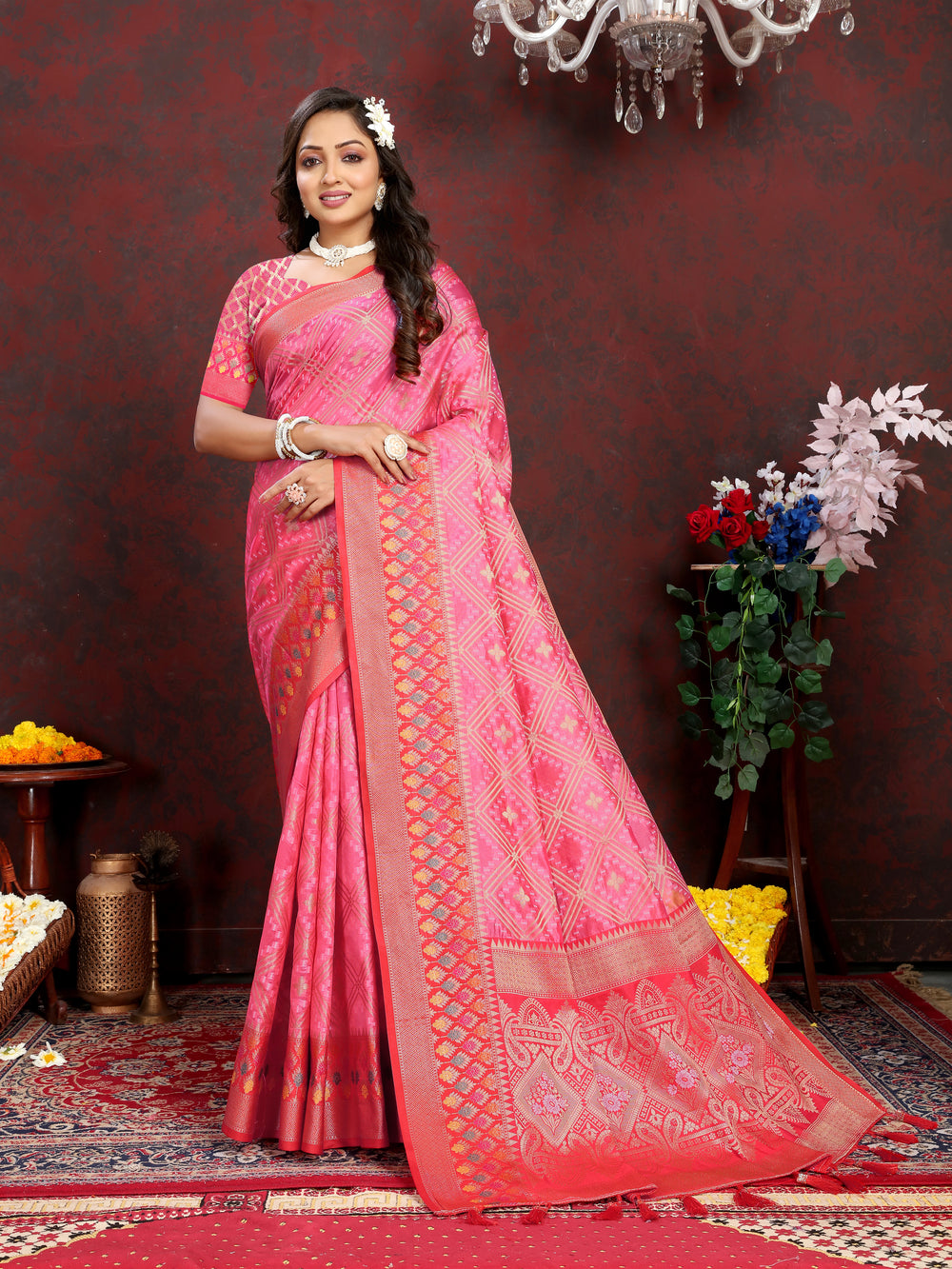 Coral pink Organza silk saree featuring luxurious zari and Meenakari pallu design, ideal for grand events.