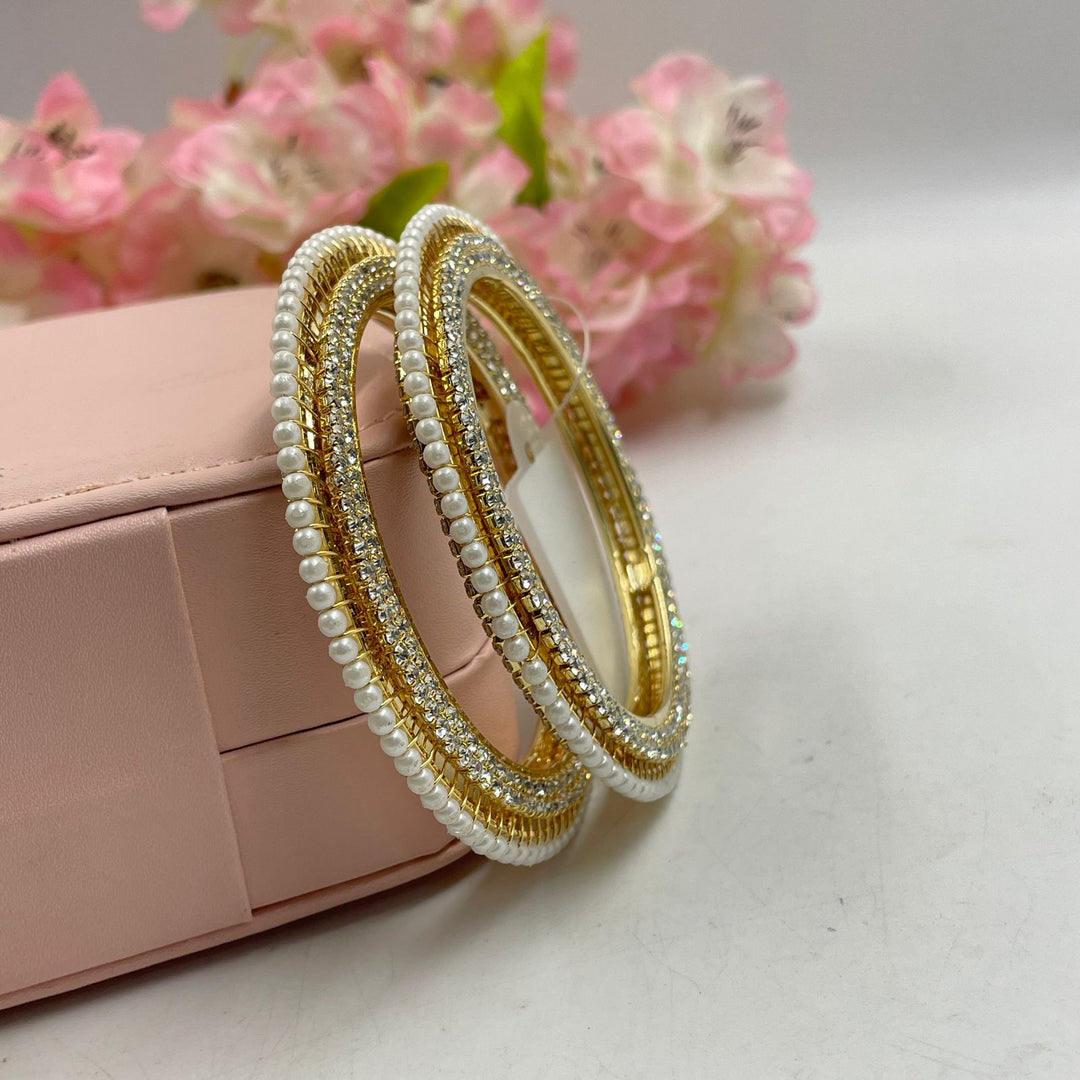 Stylish golden bangles that transition seamlessly from day to night.