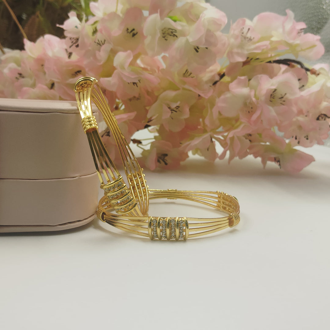 Gold-plated bangles with an antique finish for a vintage charm.