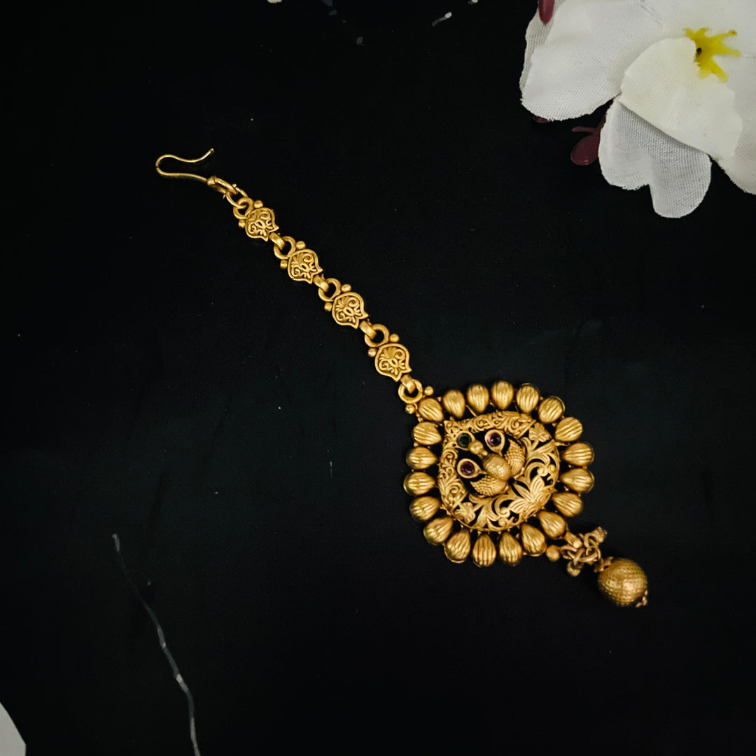 Charming golden tika that enhances the elegance of brides on their wedding day.