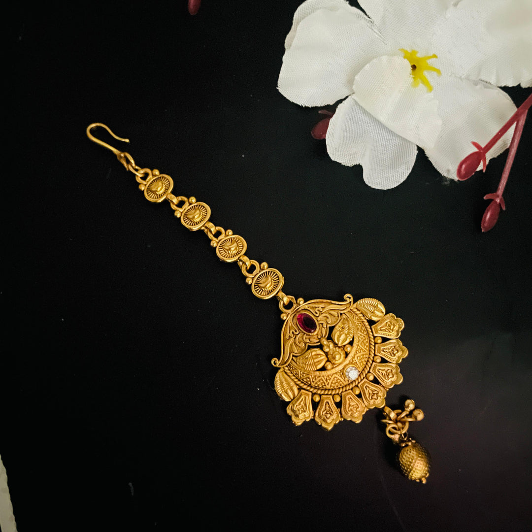 Fashionable golden maang tikka designed to complement traditional bridal attire.