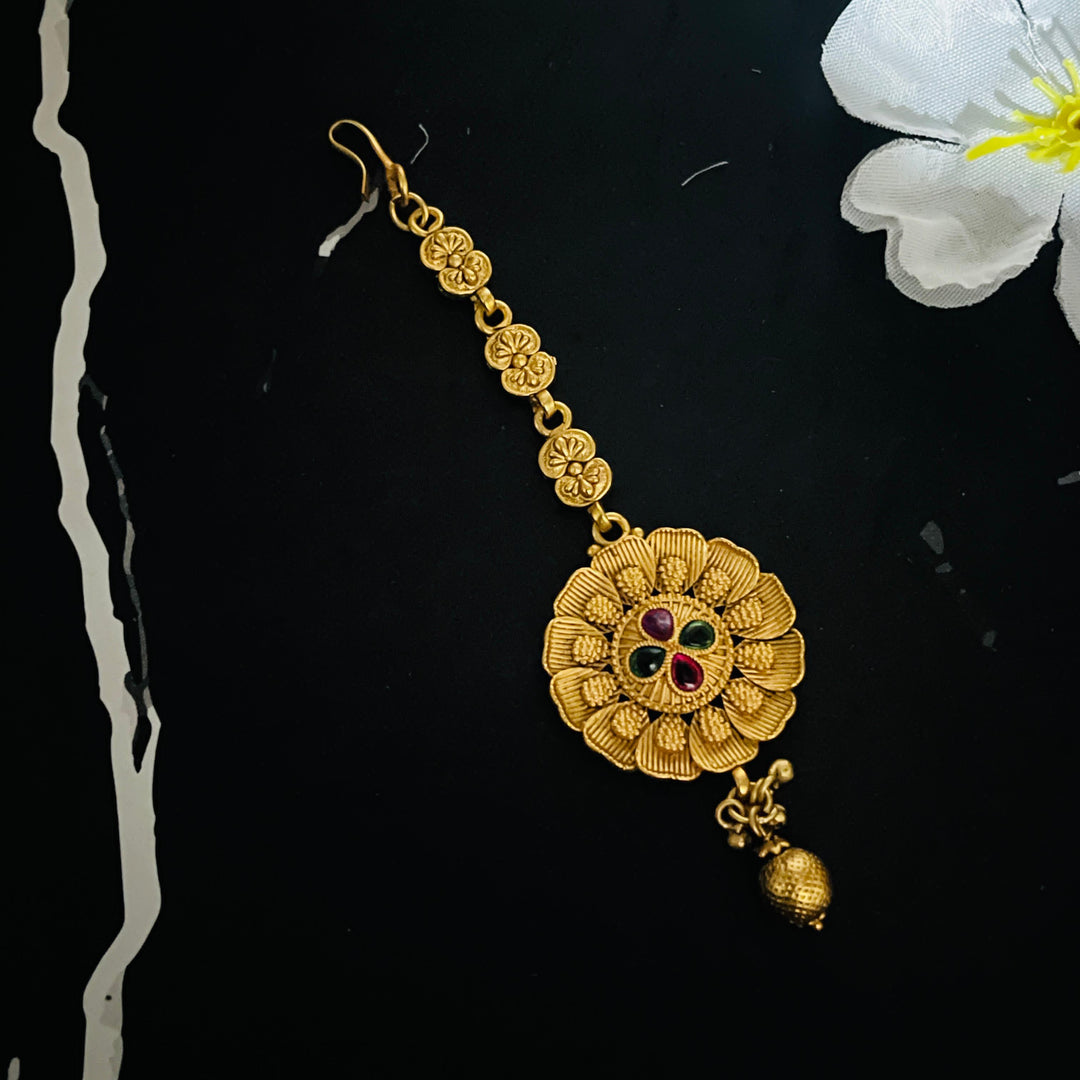 Exquisite gold maang tikka, a statement piece for brides and celebrations.