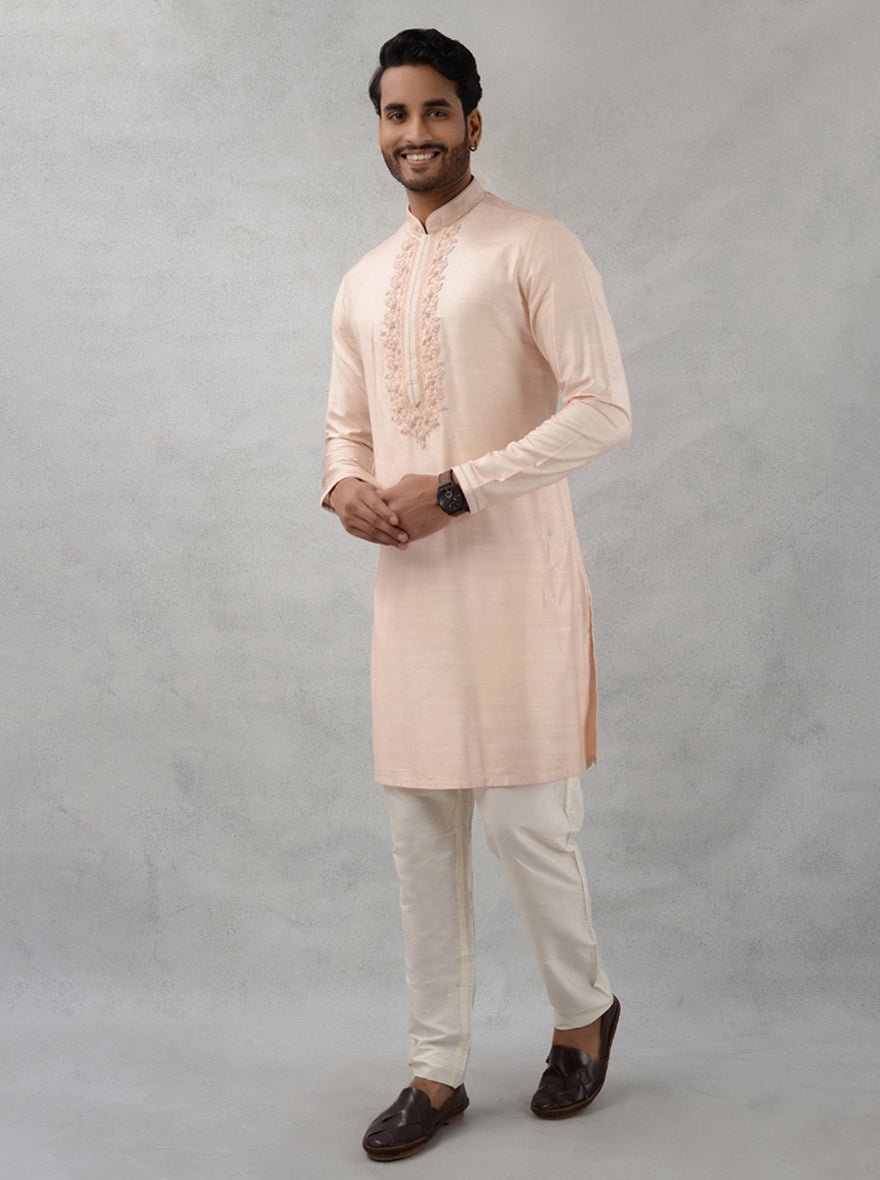 Celebrate in style with this luxurious peach silk kurta set for festive occasions.