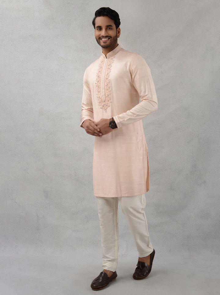 Celebrate in style with this luxurious peach silk kurta set for festive occasions.