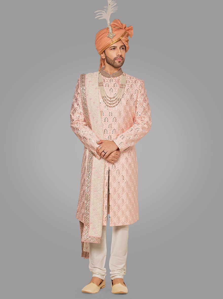 This pink sherwani features intricate Resham and sequin embroidery, perfect for traditional celebrations.