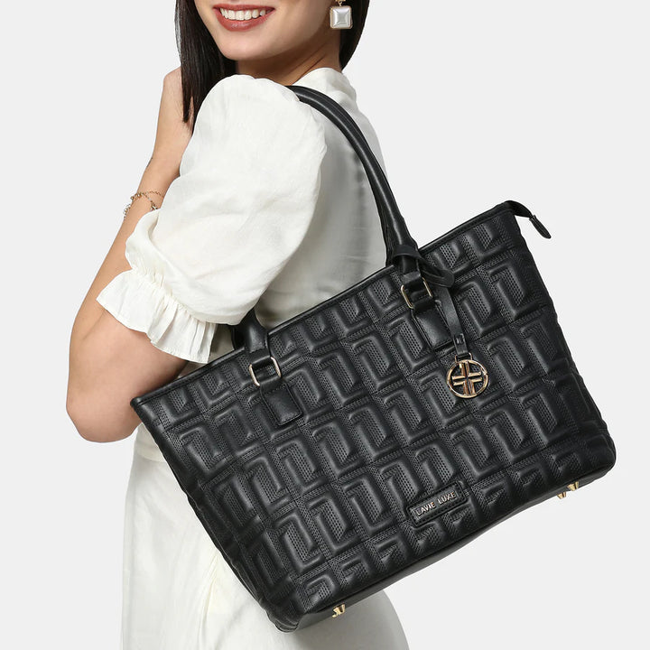 The Lavie Luxe Quilted Black Tote features a sophisticated quilted pattern, adding a chic touch to any outfit or occasion.