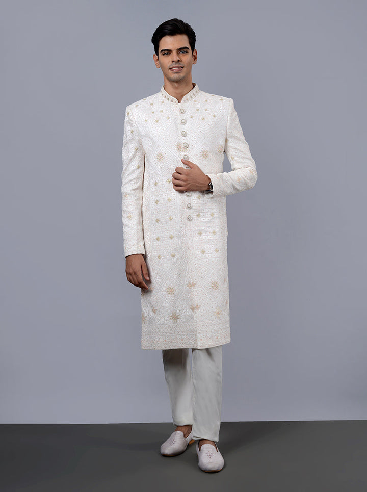 Luxurious off-white sherwani with lavish embroidery, designed for the modern groom.