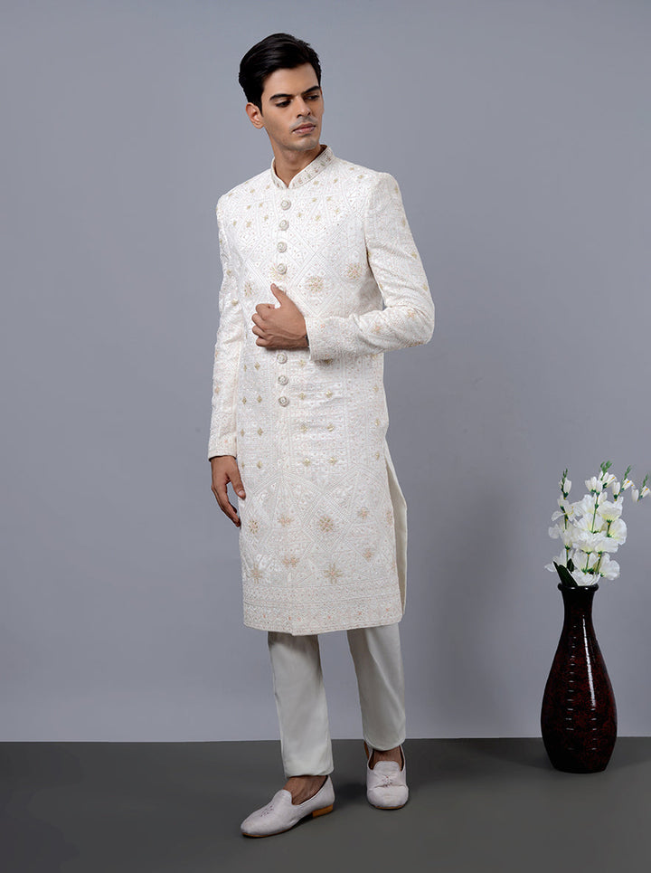 Shop our luxurious off-white sherwani, tailored for the modern groom with lavish embroidery.