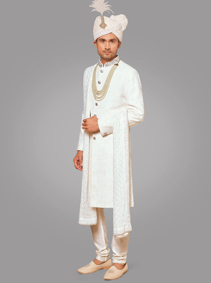 This off-white sherwani features delicate embroidery, adding a touch of elegance to your attire.