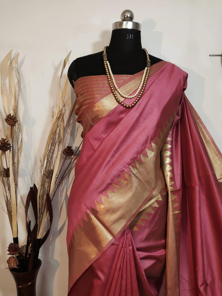 Beautiful pink designer saree with zari woven temple border, perfect for showcasing ethnic fashion at any special event.