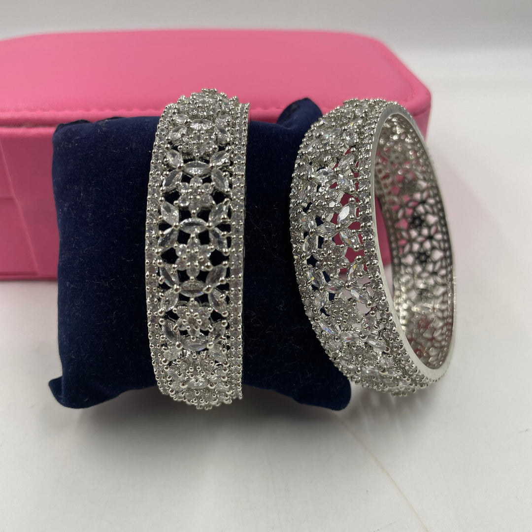 Stunning silver AD diamond bangles featuring intricate designs and sparkling accents for a glamorous look.