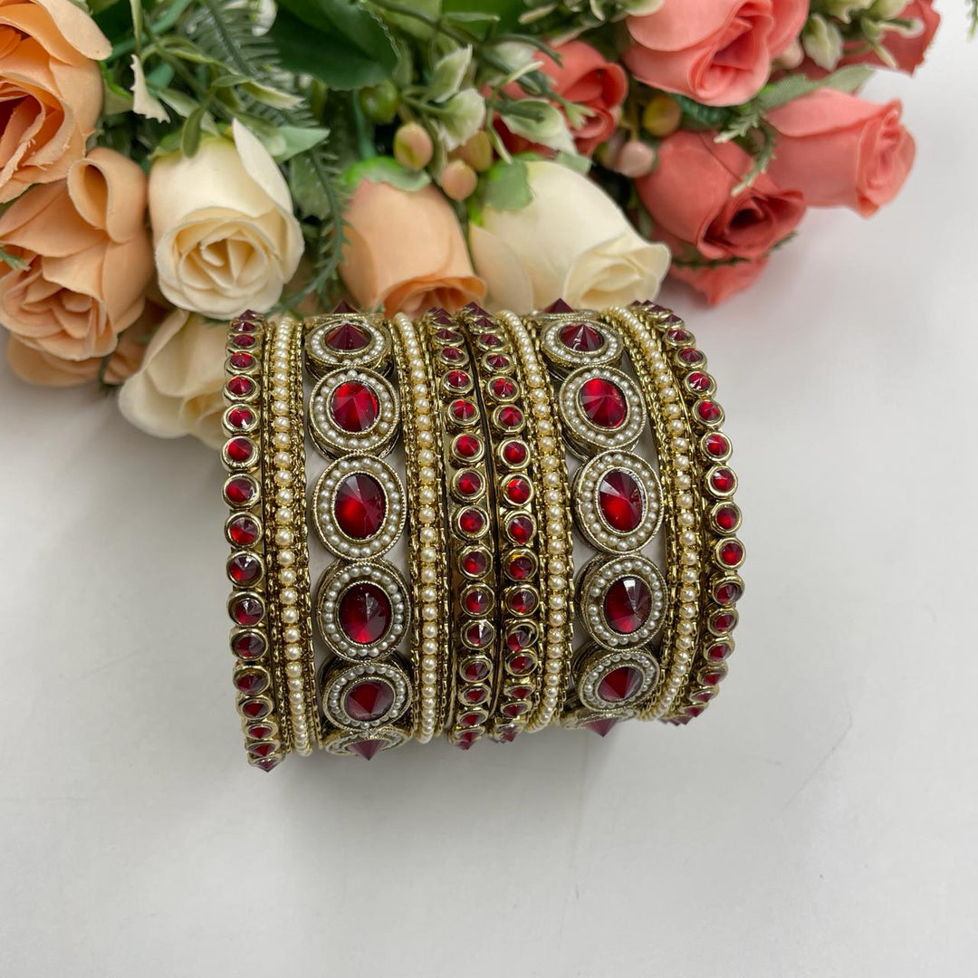 Elegant chuda set embellished with gold accents, perfect for festive occasions and weddings.