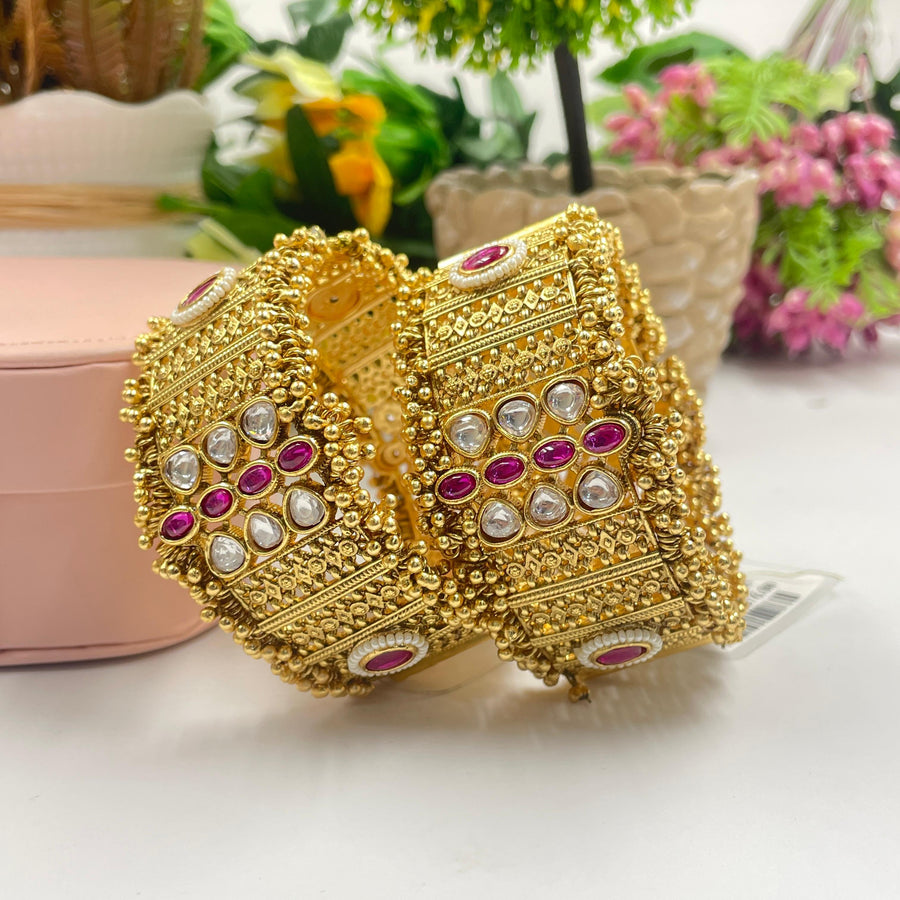 Artisan-crafted golden bangles with intricate detailing.